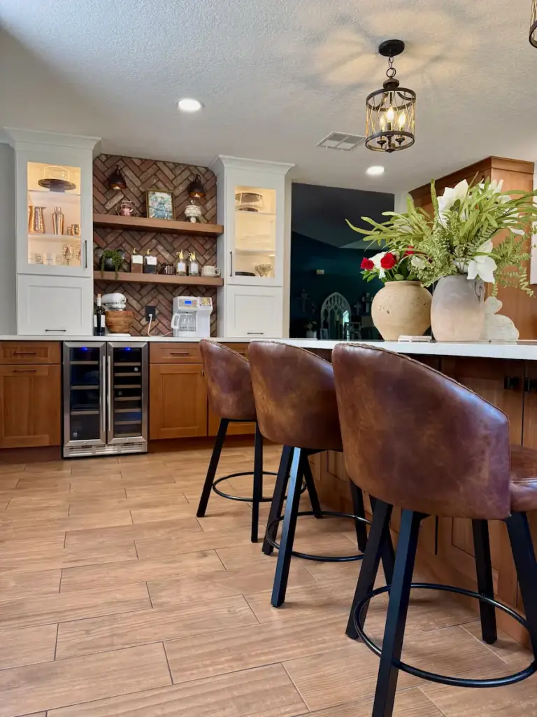 Custom kitchen remodel in Winter Park, FL with wood cabinetry, island seating, and brick backsplash