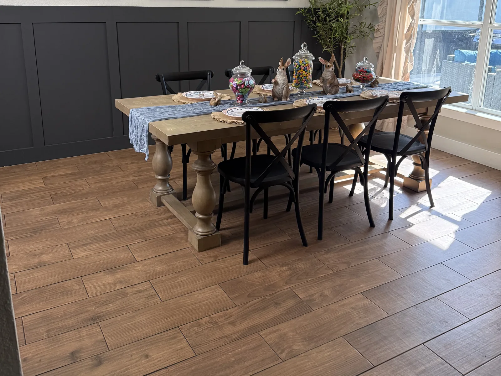 Dining room remodel in Winter Garden, FL with board-and-batten wainscoting and wood-look tile floors by Posada Remodeling & Design